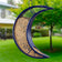 Over the Moon Fly-Thru Bird Feeder, crescent-shaped, glossy blue, filled with seeds, hanging outdoors, offers birds a spacious perch for feeding.
