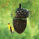 Acorn Shaped Mesh Feeder (Out of Stock): A small yellow bird perches on a decorative acorn-shaped bird feeder filled with sunflower seeds.