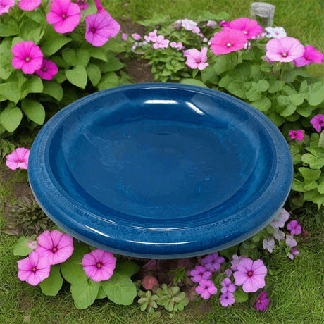 Azure fiber clay birdbath bowl surrounded by pink and purple flowers