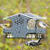 Duncraft Three-In-One Bird Feeder with multiple birds feeding from mesh and suet cages, featuring a tail prop area and durable recycled plastic construction.