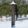Tails Upside Down Finch Tube Feeder with seeds, featuring six upside-down feeding ports, durable polycarbonate tube, and pearl finish metal caps.