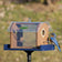 Duncraft Protected Bluebird Haven Feeder with Pole, featuring clear sides, predator guards, and a 72-inch sectional pole. Bluebird perched on feeder, keeping starlings out.