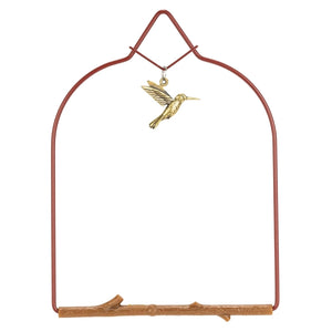 Decorative metal arch with a gold hummingbird ornament on a white background