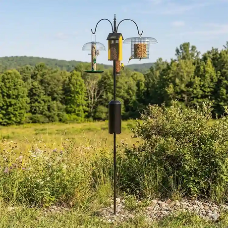 Squirrel-Proof Super Tall Quad Hanger featuring a three-arm pole with squirrel baffle, set in a grassy outdoor area, holds multiple bird feeders.